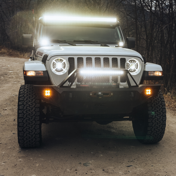 heretic quattro led fog light kit for jeep rubicon in amber mounted on a jeep