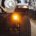 heretic quattro led fog light kit for jeep rubicon in amber mounted on a jeep
