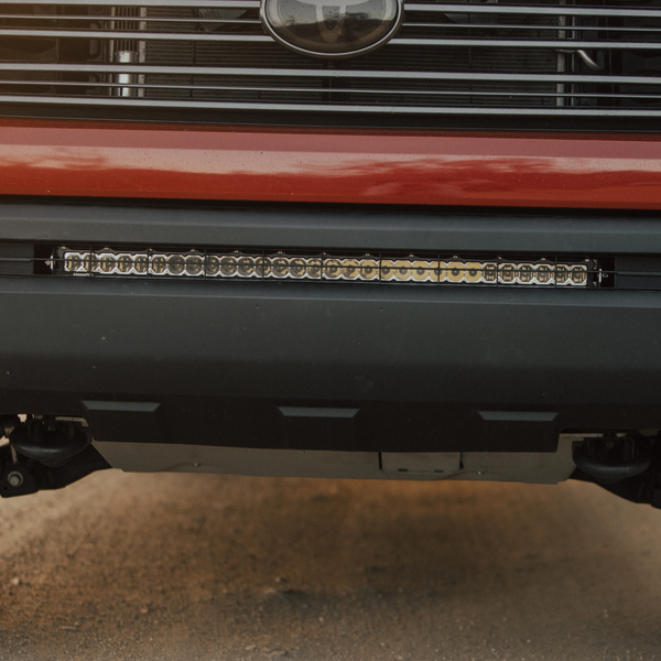 close up of a clear behind the grille light bar mounted on a toyota tundra